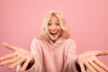 Wow offer concept. Surprised young lady with open mouth and palms posing over pink background, closeup Royalty Free Stock Photo