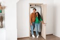 Portrait of excited emotional couple walking in their apartment