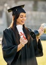 Wow, this is such an honour. a student holding her diploma and trophy on graduation day. Royalty Free Stock Photo