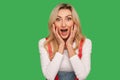 Wow, unbelievable! Portrait of excited amazed adult blond woman touching face and shouting in surprise Royalty Free Stock Photo