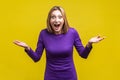 Wow, unbelievable! Portrait of positive astonished woman with widely open mouth and big eyes. isolated on yellow background Royalty Free Stock Photo