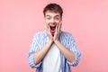 Wow, unbelievable! Portrait of shocked brown-haired man with amazed face. indoor studio shot isolated on pink background