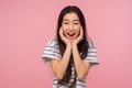 Wow, unbelievable success! Portrait of amazed girl with long hair in striped t-shirt screaming in surprise Royalty Free Stock Photo