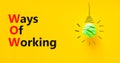 WOW ways of working symbol. Concept words WOW ways of working on a beautiful yellow background. Green light bulb icon. Business Royalty Free Stock Photo