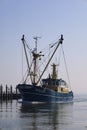 WR-109 blue boat moored at the dock on the calm body of water