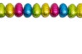 Wrapped chocolate Easter eggs in a row isolated on white. Royalty Free Stock Photo