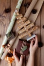 Wrapped Christmas gifts in craft paper on wooden table. Process of wrapping gifts. Lifestyle background. View from above. Royalty Free Stock Photo