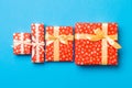 Wrapped Christmas or other holiday handmade present in paper with gold ribbon on blue background. Present box, decoration of gift Royalty Free Stock Photo