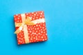 Wrapped Christmas or other holiday handmade present in paper with Gold ribbon on blue background. Present box, decoration of gift Royalty Free Stock Photo