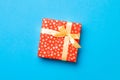 Wrapped Christmas or other holiday handmade present in paper with Gold ribbon on blue background. Present box, decoration of gift Royalty Free Stock Photo