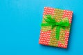 Wrapped Christmas or other holiday handmade present in paper with green ribbon on blue background. Present box, decoration of gift Royalty Free Stock Photo