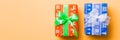 Wrapped Christmas or other holiday handmade present in paper with white and green ribbon on orange background. Present box, Royalty Free Stock Photo