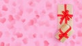 Wrapped craft paper box with gifts decorated with red bow on pink background. Flat lay still life for Christmas holiday, Valentine