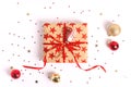 Wrapped gift box with red ribbon and bow on white wooden background. Royalty Free Stock Photo