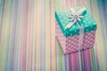 Wrapped gift box on stripy fabric background holidays concept