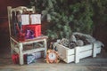 Wrapped gift boxes with ribbons as Christmas gifts on a chair under a Christmas tree. Christmas still life Royalty Free Stock Photo