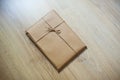Wrapped gift kraft paper on a wooden background
