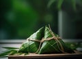 Wrapped Glutinous Rice with Green Leaves Triangular Zongzi Food Steamer Made of Bamboo on Selective Focus Background