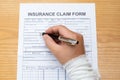 Wrapped hand filling up an insurance claim form medical and insurance concept no logo trademark Royalty Free Stock Photo