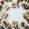 Wrapped holiday gifts arranged in a circular pattern surrounded by pine branches and cones Royalty Free Stock Photo