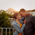Wrapped in love. Shot of a happy young couple enjoying a romantic moment in the city. Royalty Free Stock Photo