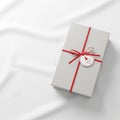 Wrapped in plain gray paper is tied with a vibrant red ribbon Royalty Free Stock Photo