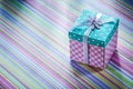 Wrapped present box on stripy fabric background celebrations con