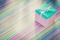 Wrapped present box on stripy fabric background holidays concept