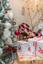 Wrapped present boxes on blurry Christmas background with garlands bokeh. White paper with red ribbon and bow, Christmas pattern Royalty Free Stock Photo