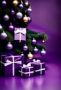 purple christmas gift parcels under a tree decorated with matching baubles Royalty Free Stock Photo