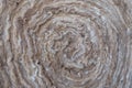 Wrapped in a roll in the clockwise direction fluffy wavy mineral wool consisting of hair layers of brown and white color.