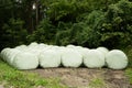 Wrapped silage bales in an alpine meadow, hay bales Royalty Free Stock Photo