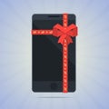 Wrapped smartphone with red ribbon and text gift