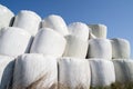 Wrapped and stacked hay bales with blue sky in the background Royalty Free Stock Photo