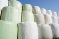 Wrapped and stacked hay bales with blue sky Royalty Free Stock Photo