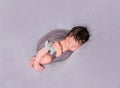 Wrapped up baby with a cat toy Royalty Free Stock Photo