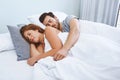 Wrapped up comfortably in love. a couple sleeping in bed together at home. Royalty Free Stock Photo