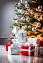 wrapped white christmas gifts under a tree decorated with matching baubles