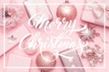 Wrapped xmas boxes, christmas ornaments and baubles. Pink christmas gifts isolated on pastel pink background. Royalty Free Stock Photo