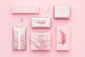 Wrapped xmas boxes. Gift wrapping. Pink nordic christmas gifts isolated on pastel pink background.