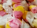 Wrapped yellow and pink taffy candies in bulk