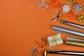 Gift wrapping utensils on orange ground