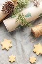 Wrapping paper with a pine branch and Christmas cookies on a textile background Royalty Free Stock Photo