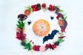 Wreath of autumn leaves, berries, cones and fruits in the center of the wreath pumpkin, spiders and bat. Halloween Royalty Free Stock Photo