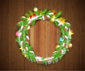 Wreath from cones and fir tree branches with snow, craft boxes, stars and toys on vintage wood background.