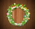 Wreath from cones and fir tree branches with snow, craft boxes, stars and toys on vintage wood background. Winter christmas horizo