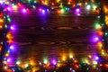 Wreath and garlands of colored light bulbs.Christmas background with lights and free text space. Christmas lights border Royalty Free Stock Photo