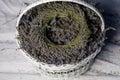 A wreath of lavender flowers in a white basket with selective focus on a blurred background. Copy space Royalty Free Stock Photo