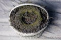 A wreath of lavender flowers in a white basket with selective focus on a blurred background. Copy space Royalty Free Stock Photo