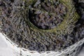 A wreath of lavender flowers in a white basket with selective focus on a blurred background. Copy space Royalty Free Stock Photo